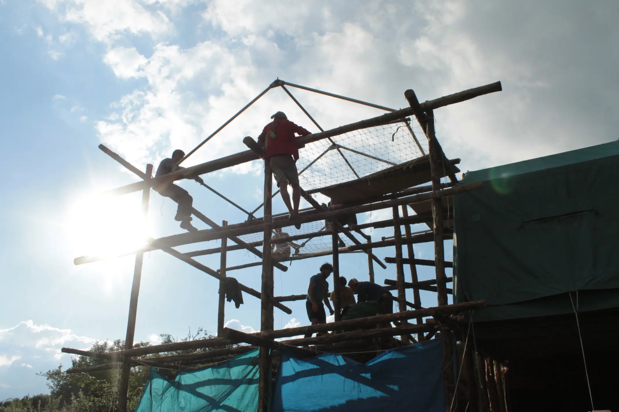 Construction de pilotis en bois par des scouts pour un camp d'été : inspiration pour illustrer 15 idées de thèmes de camp scout, guides et patro